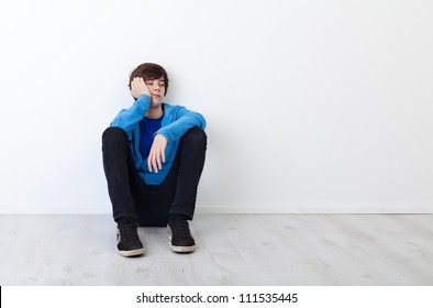 I Am Not In The Mood Today - Bored Teenager Boy Sitting By The Wall
