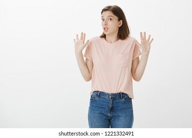 It Was Not My Fault, I Have Nothing To Deal With It. Confused Innocent Attractive Female Friend In Casual Clothes, Raising Palms In Surrender, Standing Surprised And Clueless Over Gray Background