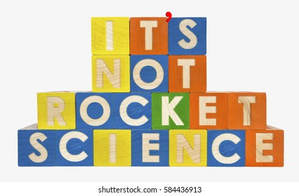 IT'S NOT ROCKET SCIENCE concept spelled with toy blocks. With apostrophe. Isolated.