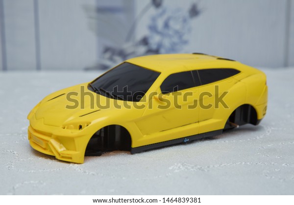 Not wheelchairs\
yellow baby car . Closeup of a yellow baby car on a white\
background . Broken yellow toy\
car