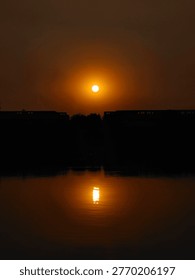 notable feature is the reflection of the sun, creating a mirror effect on the water's surface. 