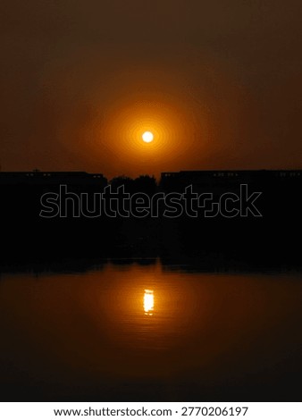 notable feature is the reflection of the sun, creating a mirror effect on the water's surface. 