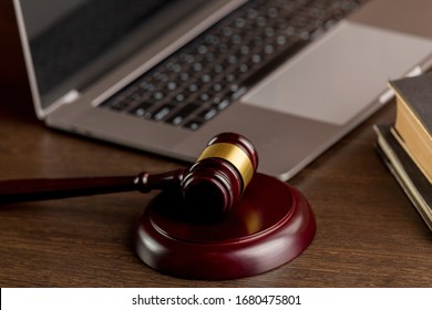 Notary concept. Wooden gavel near the laptop.