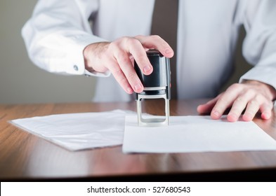 Notary public in office stamping document,vertical photo - Shutterstock ID 527680543