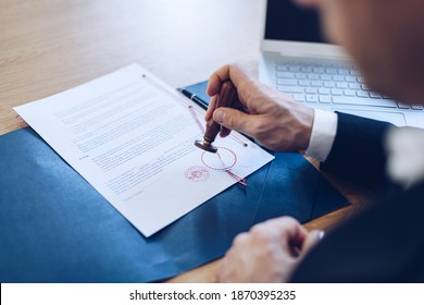 Notary Public Stamping And Notarize Document In His Office