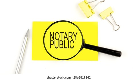 NOTARY PUBLIC Text On The Sticker Through Magnifier. View From Above. Business