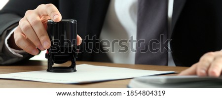Notary stamping document at table, closeup. Banner design