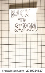 A Note with Back to School on it, on a White background. Back To School background.