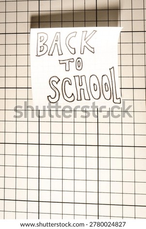 A Note with Back to School on it, on a White background. Back To School background.