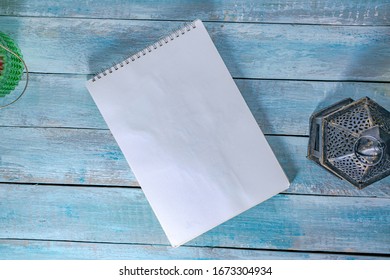 Note Book On Wood Background With Lantern And Beauty Lamp Can Be Used As Mock Up For Design 