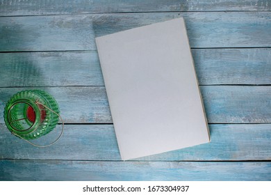 Note Book On Wood Background With Lantern And Beauty Lamp Can Be Used As Mock Up For Design 