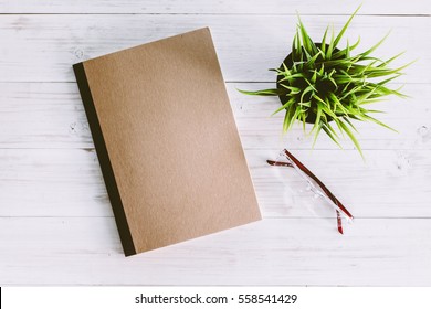 Note Book On Wooden Background