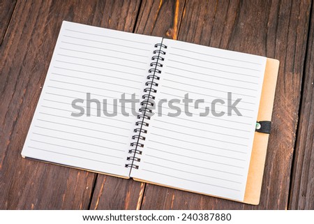 Note book on wooden background - vintage effect style picture