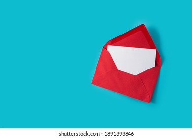 Note Inside Red Envelope On Blue Background. Copy Space