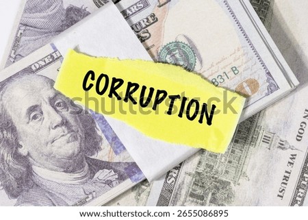 A note marked “Corruption” is set on a spread of cash, highlighting misuse of public funds and unethical financial practices.

