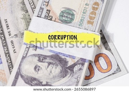 A note marked “Corruption” is set on a spread of cash, highlighting misuse of public funds and unethical financial practices.

