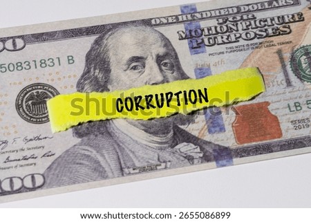 A note marked “Corruption” is set on a spread of cash, highlighting misuse of public funds and unethical financial practices.


