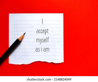 Note on red background with affirmation message I ACCEPT MYSELF AS I AM, concept of phrases statements repeated to help encourage self worth and raise self esteem, love and value self unconditionally - Shutterstock ID 2148824049