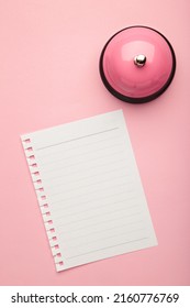 Note On The Service Bell On Pink Background. Top View