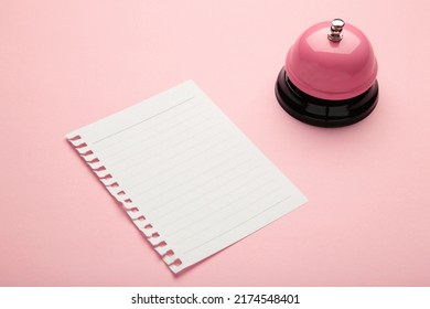 Note On The Service Bell On Pink Background. Top View