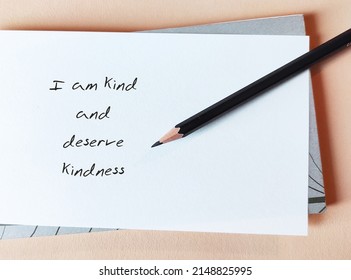 Note Paper With Handwritten Message I AM KIND AND DESERVE KINDNESS, Concept Of Positive Affirmation Self Talk To Raise Self Esteem, Challenge Negative Perception, Boost Self Respect And Acceptance