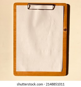 Note Paper Holder File Made Of Wood On White Desk And White Paper Pinned On It