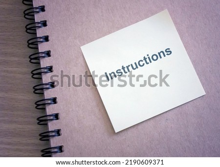 note paper on brown notebook with message Instructions , User Manual