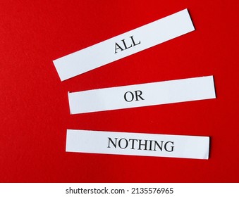 Note Paper On Red Background With Text Written ALL OR NOTHING Means Doing Something Either Completely Or Not At All - Not Allowing For Qualification Or Compromise