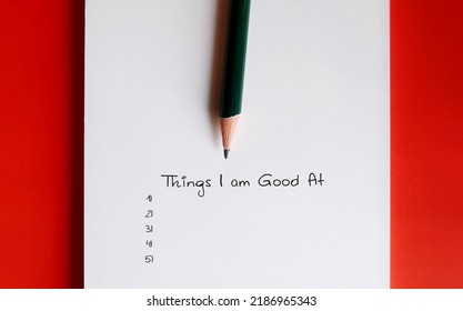 Note Paper On Red Background With List Of Things I Am Good At - Concept Of Figure Out Strengths, Discover Hard And Soft Skills To Find Passion Or Unique Abilities