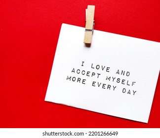 Note Paper On Red Background With Text Written - I Accept And Love Myself More Every Day - Concept Of Self-love And Acceptance Which Encourage Self-esteem, Accept Mistakes And Imperfection