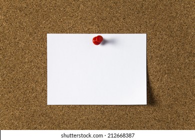 Note Paper With Red Pin On The Cork Board