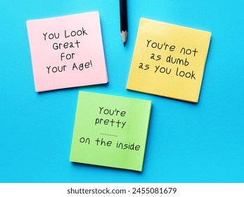 Note paper with sample of Backhanded Compliments - remark which seems to be an insult than compliment, seems positive but has a negative undertone
