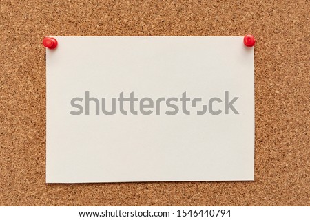 Note paper swith push pins on cork board. Empty paper pages for notes copy space for text.