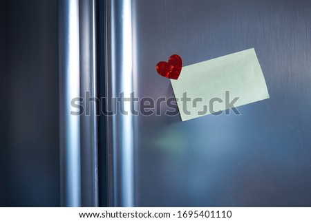 note at refridgerator with heart sticker to send the message in the kitchen