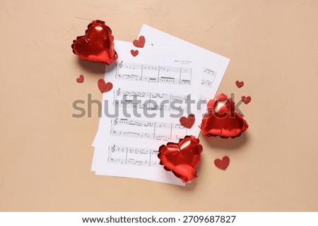 Note sheets with balloons and hearts on beige background. Valentine's Day celebration