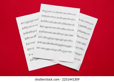 Note sheets on red background, flat lay