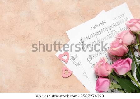 Note sheets with pink roses and hearts on beige grunge background. Valentine's Day celebration
