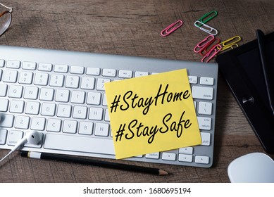 Note Stay Home Stay Safe On The Keyboard, Mouse And Tabs On The Table