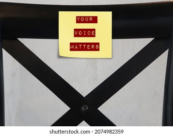 Note stick on black chair back with text written YOUR VOICE MATTERS, concept of expressing one internal world out to the public space, every voices deserves to be heard