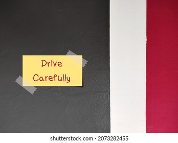 Note Stick On Car Park Wall With Handwritten Text DRIVE CAREFULLY, Advise Departing Person To Be Careful While Driving, Self Reminder Or Parents Remind Teenage Driver To Drive  With Responsibility