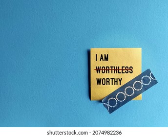 Note stick on copy space blue background with text I AM WORTHLESS change to I AM WORTHY, concept of self talk affirmation to overcome low self esteem, to love and accept value of oneself - Shutterstock ID 2074982236