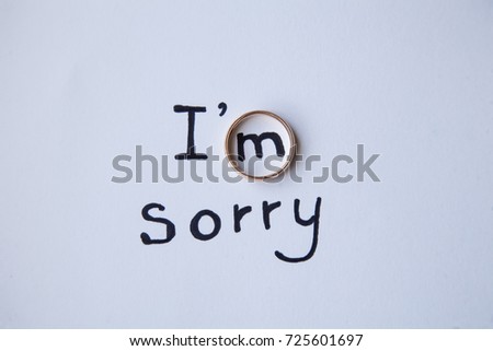 Note with the words, "I'm sorry", next to a wedding ring.