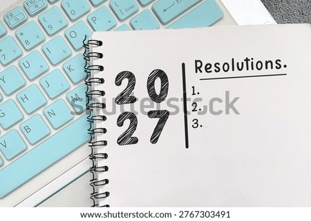 Notebook with 2027 resolution list. Concept of planning, goals, and personal productivity.