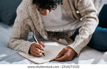 Notebook, bed and man with home planning, brainstorming and studying notes, education and mental health. Journal, goals and person writing in bedroom for learning, planner and schedule or reminder