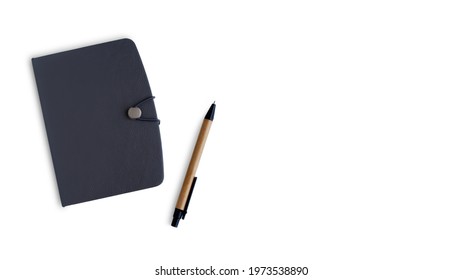 Notebook black leather cover portable is closed and pen, Isolated on white background with copy space, Pocket book for Organizer planner or Business management, Office and Collect write lecture memo.