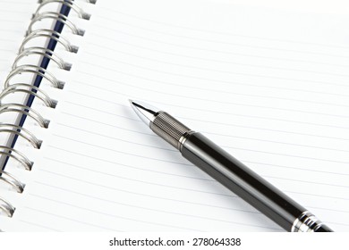 Notebook with black pen  