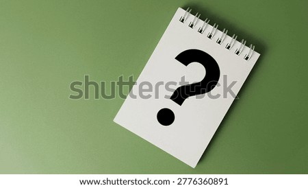 Notebook with Black Question Mark on Green Background Concept of Curiosity Inquiry FAQ Idea Generation Thinking and Problem Solving. 