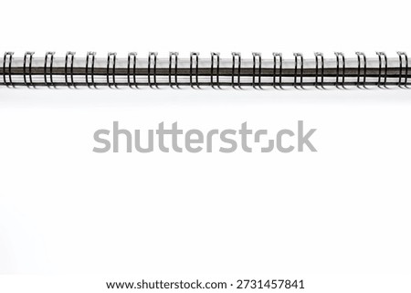 Notebook with black spring on the side on top