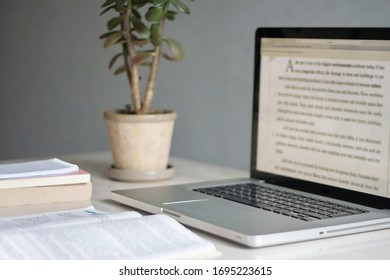 Notebook, books and plant on the table. Study online. Online learning concept.  - Shutterstock ID 1695223615