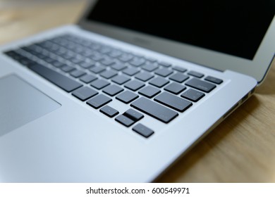 Notebook computer placed on a wooden desk. - Shutterstock ID 600549971
